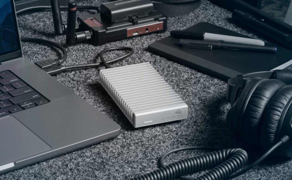 An SSD drive on the desktop next to a computer