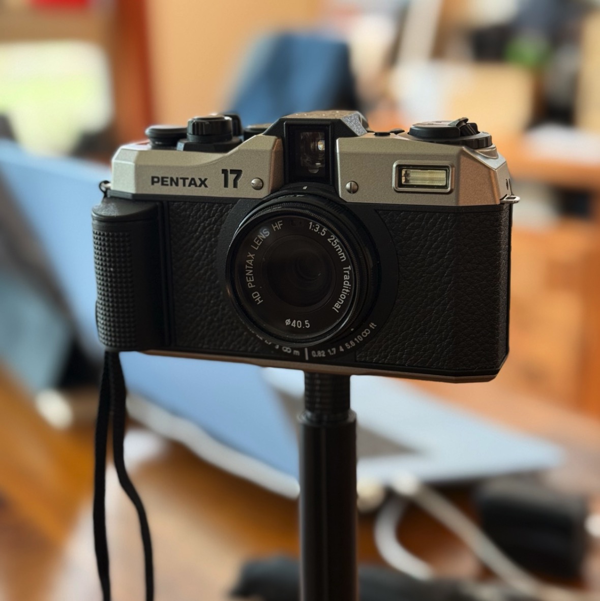 The pentax 17 product shot in a room.