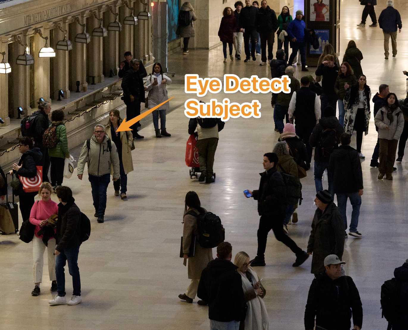 A man walking across the concourse tracked by Nikon's system. 